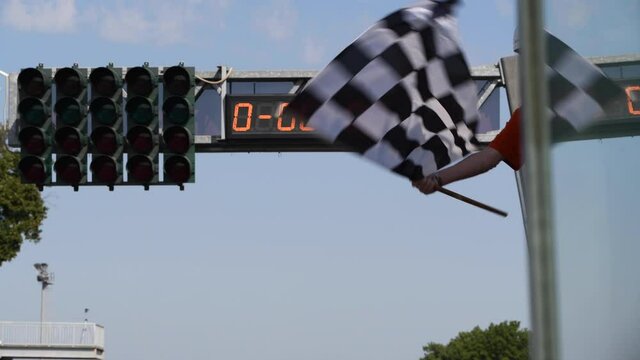 Waving checkered flag on motorsport circuit finish line real time success in competition concept
