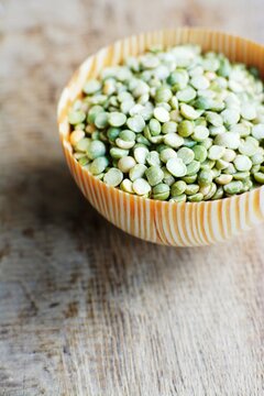 Green split peas in a wooden bowl