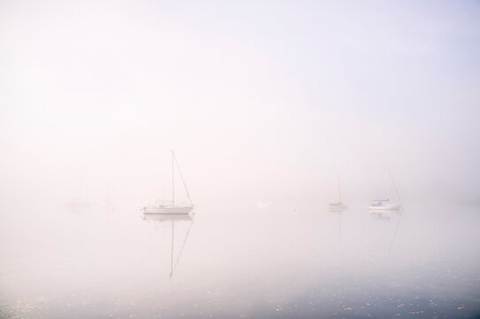 Boats in fog on Lake Windermere.
