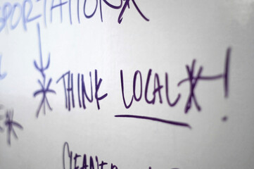 Think Local!"" handwritten on whiteboard