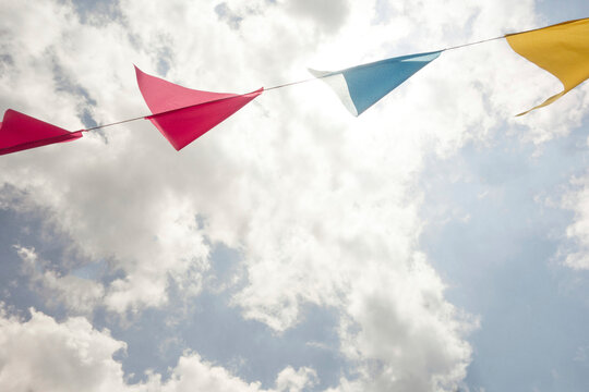 Festive colorful flags / banners against sky