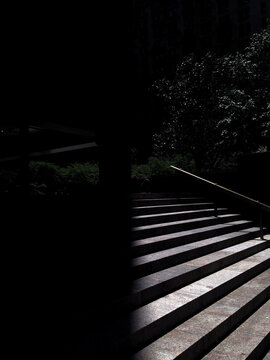 Sun shining in on half of a stair case