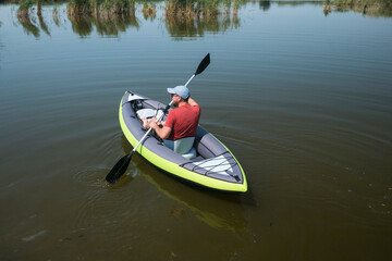 Fototapeta premium young male swim on kayak on the river