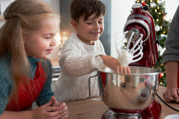 Children helping mother with Christmas baking