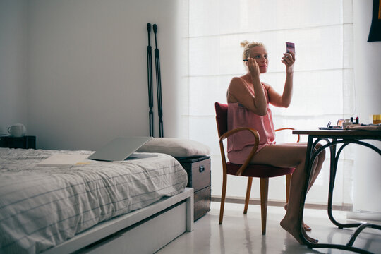 Blonde Woman Putting on Make Up in the Morning