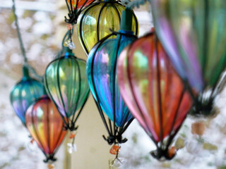 ornamental holiday lights, tear-drop shaped, against a snowy, wintry background