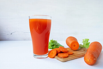 Healthy fresh carrot juice on the white table