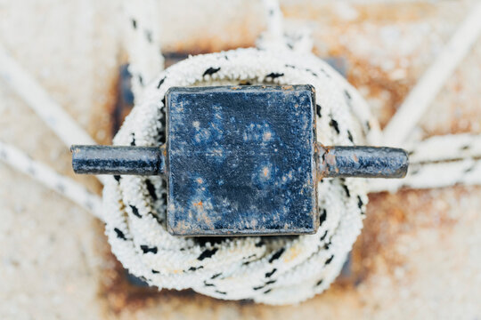 Rope tied up to a square nautical cleat