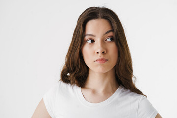 Pensive young woman thinking isolated over white