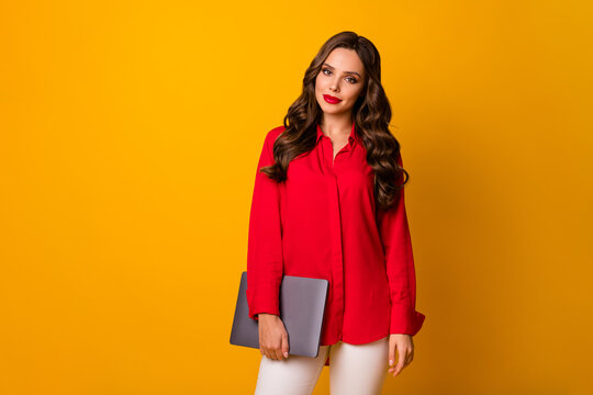 Photo of attractive wavy lady hold closed notebook hands workshop meeting modern technology user wear red office shirt white pants isolated yellow bright color background