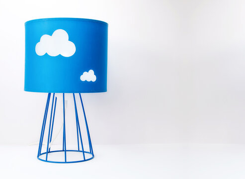 Blue Table Lamp With Clouds On A Table On A Light Background.