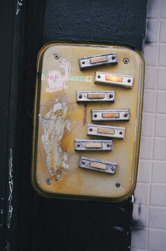 A bunch of doorbells installed in a messy fashion.