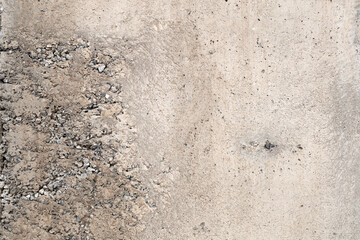 Cracked grey concrete texture closeup background.