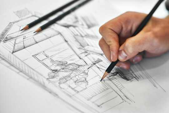 Creative architect and interior designer working on hand drawing architectural sketch with black pencil on white paper