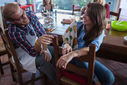 Couple of Friends Laughting During a Meal Party