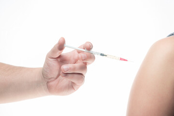 mano caucasica aplicando vacuna de coronavirus covid-19 con fondo blanco, en buenos aires argentina (caracter ilustrativo)