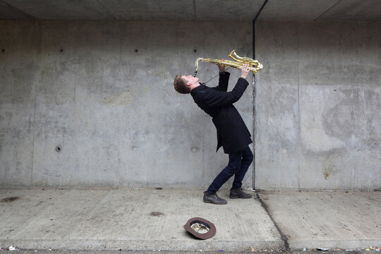 Saxophone player in urban tunnel