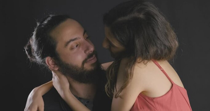 Young happy man and woman in love,studio shot. Passion and relationship concept. Lovers emotion, youth and couple.
