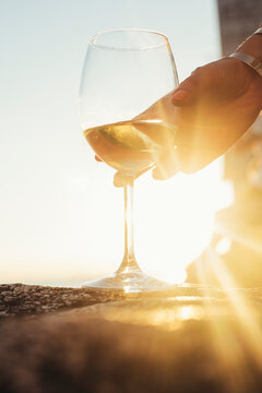 Woman's Hand Takes a Glass of White Wine