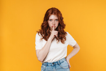 Image of ginger confused girl showing silence gesture