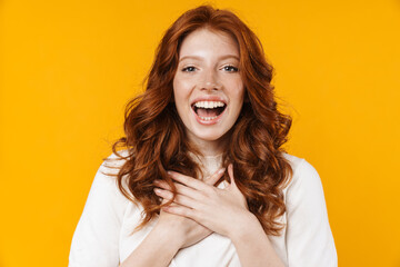 Image of excited girl expressing surprise with hands on her chest