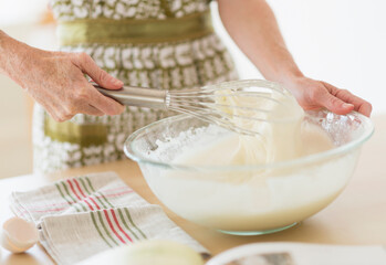 Midsection of woman whisking batter