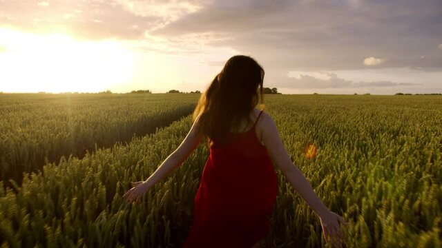 Beautiful woman running to meet the sunset