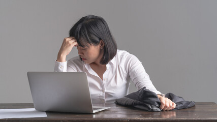 Office workers are working with high stress. At the work desk there is a labtop. Concept of working with stress