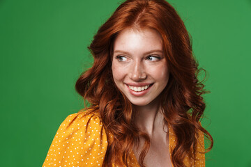 Fototapeta premium Image of ginger joyful girl laughing and looking aside