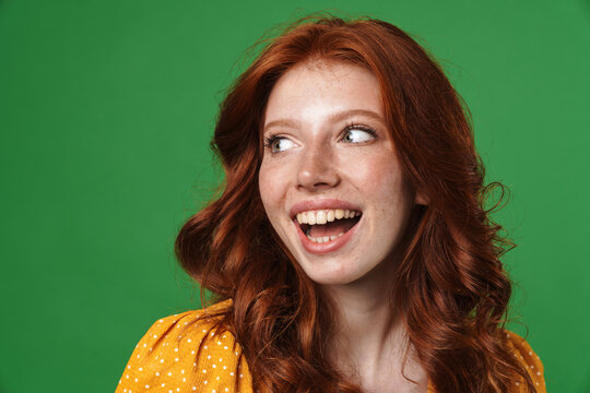Image of ginger joyful girl laughing and looking aside