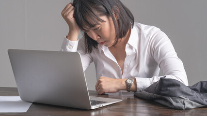 Office workers are working with high stress. At the work desk there is a labtop. Concept of working with stress