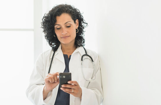 Female doctor using cell phone