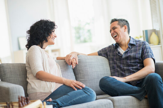 Couple talking on sofa