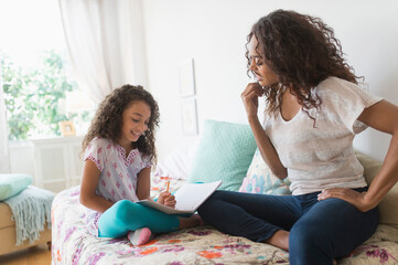 Mother and daughter (8-9) studying together