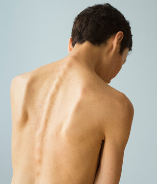 Rear view of shirtless senior woman