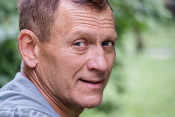 Close up portrait of smiling middle aged man.