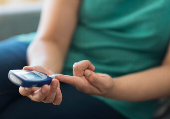 Woman sitting on sofa with mobile phone