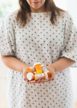 Woman With Pill Bottles In Hands