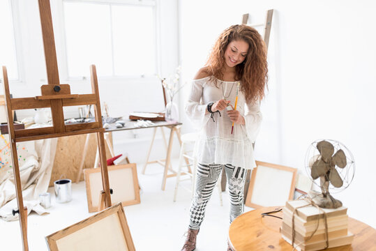 Young female artist in studio