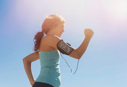 Side view of young woman power walking
