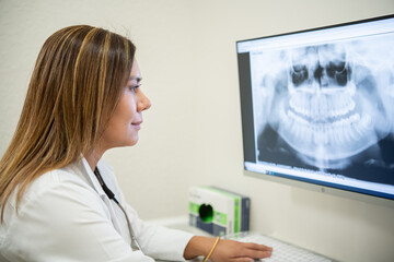 Fototapeta na wymiar A dentist looking at x-rays