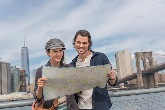 Happy couple reading map