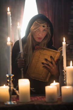Portrait of sorceress in dark room