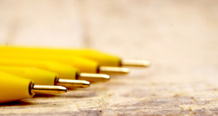 Yellow pen on wood background
