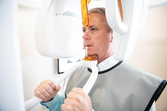 An adult male patient having a panorama x-ray at a dentist office
