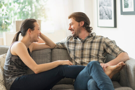 Cheerful couple relaxing on sofa