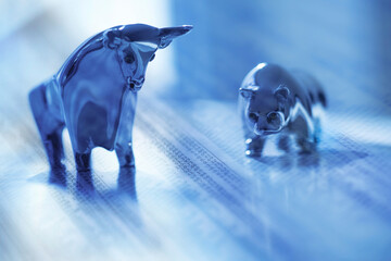 Digital composite with ceramic animals and financial newspaper