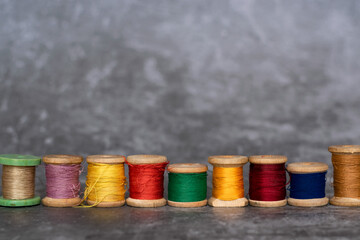 Different colorful cotton mill on grey background