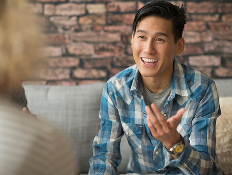 Smiling man talking to friend