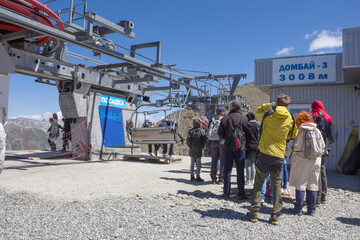 Dombay, Karachay-Cherkessia, Russia - August 15, 2020: A group of people waiting to board the lift at an altitude of 3008 meters in Dombay